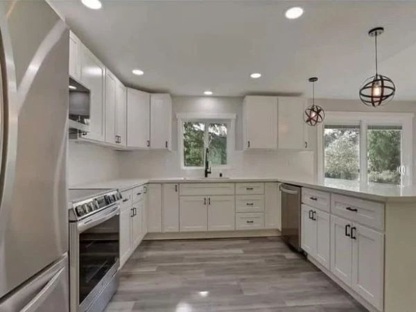 Remodeled white shaker kitchen with quartz counters in a Thurston County home